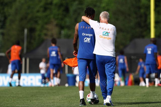 France's head coach Didier Deschamps (R) reacts with France's forward #11 Michael Olise during a training session at Bentley University, the team's base camp, as part of the 2026 World Cup football tournament in Waltham, near Boston, on June 12, 2026. (Photo by FRANCK FIFE / AFP)
