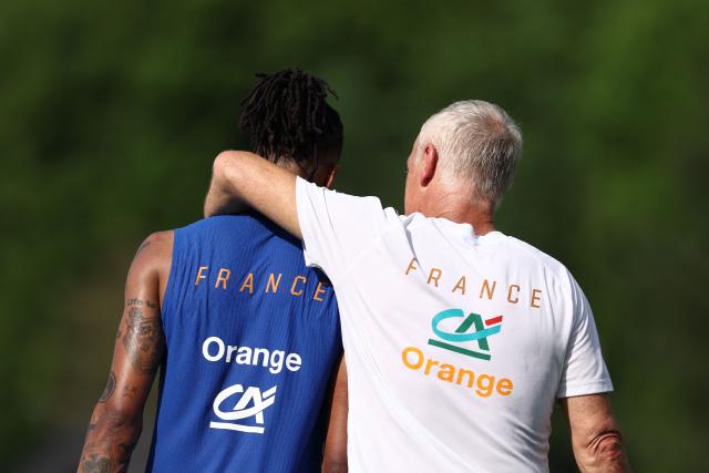 France's head coach Didier Deschamps (R) reacts with France's forward #11 Michael Olise during a training session at Bentley University, the team's base camp, as part of the 2026 World Cup football tournament in Waltham, near Boston, on June 12, 2026. (Photo by FRANCK FIFE / AFP)