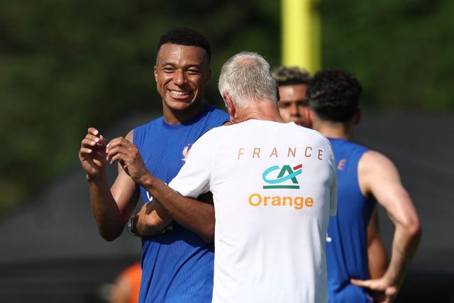 France's head coach Didier Deschamps (R) and France's forward #10 Kylian Mbappe react as they take part in a training session at Bentley University, the team's base camp, during the 2026 World Cup football tournament in Waltham, near Boston, on June 12, 2026. (Photo by FRANCK FIFE / AFP)