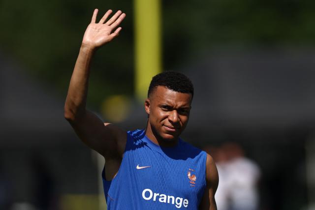 France's forward #10 Kylian Mbappe waves to attendees as he takes part in a  training session at Bentley University, the team's base camp, during the 2026 World Cup football tournament in Waltham, near Boston, on June 12, 2026. (Photo by FRANCK FIFE / AFP)