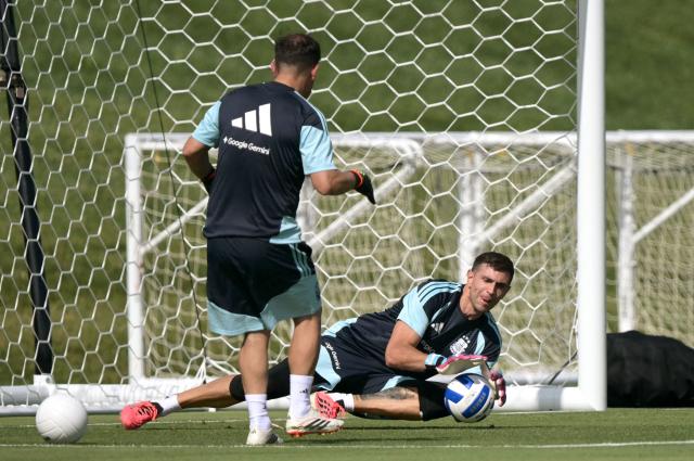 Argentina's goalkeeper #23 Emiliano Martinez dives for the ball during a training session for the 2026 FIFA World Cup football tournament at Sporting KC Training Centre in Kansas City on June 12, 2026. (Photo by JUAN MABROMATA / AFP)