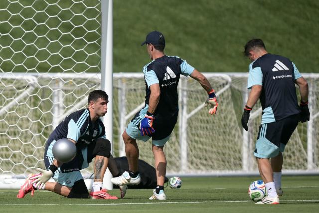Argentina's goalkeeper #23 Emiliano Martinez (L) blocks a ball during a training session for the 2026 FIFA World Cup football tournament at Sporting KC Training Centre in Kansas City on June 12, 2026. (Photo by JUAN MABROMATA / AFP)