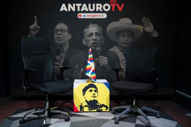 An image showing Antauro Humala (C), leader and founder of the Ethnocacerist party and promoter of Peruvian ultranationalism, Peru's presidential candidate Roberto Sanchez (L) and former Peruvian president Pedro Castillo is seen at the Ethnocacerist party headquarters in Lima on June 12, 2026. Peru is heading toward a deeper governance crisis and protests if right-wing candidate Keiko Fujimori prevails over leftist Roberto Sanchez in the tight presidential vote count, nationalist leader Antauro Humala told AFP on June 12. (Photo by Ernesto BENAVIDES / AFP)
