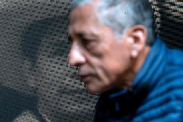 Antauro Humala, leader and founder of the Ethnocacerist party and promoter of Peruvian ultranationalism, looks on in front of an image of former Peru's President Pedro Castillo during an interview with AFP at the Ethnocacerist headquarters in Lima on June 12, 2026. Peru is heading toward a deeper governance crisis and protests if right-wing candidate Keiko Fujimori prevails over leftist Roberto Sanchez in the tight presidential vote count, nationalist leader Antauro Humala told AFP on June 12. (Photo by Ernesto BENAVIDES / AFP)