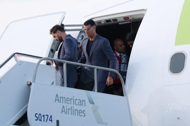 Portugal's forward #07 Cristiano Ronaldo (R) and Portugal's midfielder #10 Bernardo Silva get off the plane upon their arrival at the Palm Beach International Airport for the FIFA 2026 World Cup football tournament, in West Palm Beach, Florida on June 12, 2026. (Photo by PATRICIA DE MELO MOREIRA / AFP)