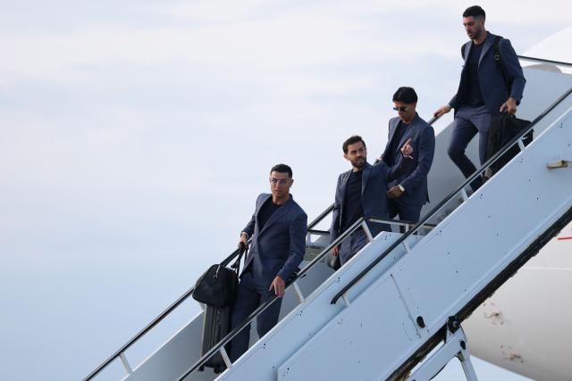(L to R) Portugal's forward #07 Cristiano Ronaldo, Portugal's midfielder #10 Bernardo Silva, Portugal's defender #20 Joao Cancelo, and Portugal's goalkeeper #01 Diogo Costa get off the plane upon their arrival at the Palm Beach International Airport for the FIFA 2026 World Cup football tournament, in West Palm Beach, Florida on June 12, 2026. (Photo by PATRICIA DE MELO MOREIRA / AFP)