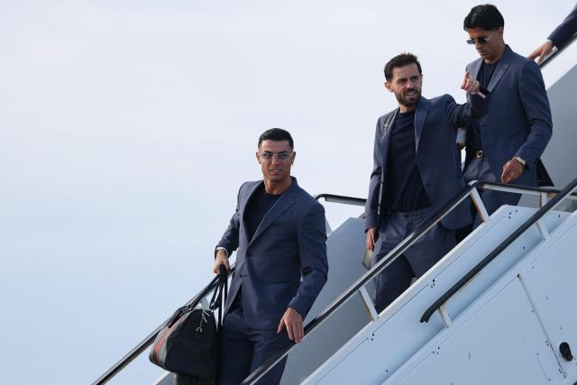 (L to R) Portugal's forward #07 Cristiano Ronaldo, Portugal's midfielder #10 Bernardo Silva and Portugal's defender #20 Joao Cancelo get off the plane upon their arrival at the Palm Beach International Airport for the FIFA 2026 World Cup football tournament, in West Palm Beach, Florida on June 12, 2026. (Photo by PATRICIA DE MELO MOREIRA / AFP)