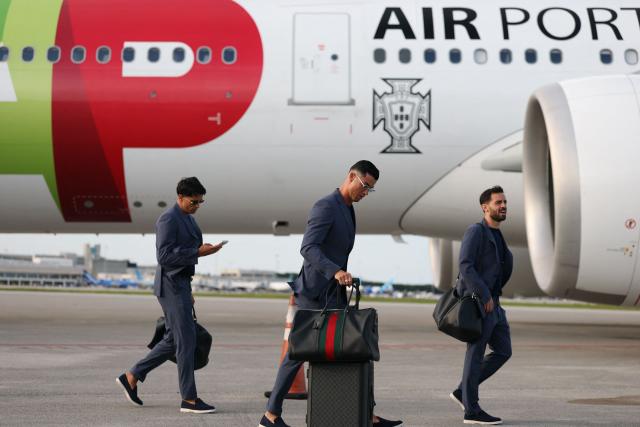 Portugal's forward #07 Cristiano Ronaldo (C), Portugal's defender #20 Joao Cancelo (L), and Portugal's midfielder #10 Bernardo Silva walk on the runway upon their arrival at the Palm Beach International Airport for the FIFA 2026 World Cup football tournament, in West Palm Beach, Florida on June 12, 2026. (Photo by PATRICIA DE MELO MOREIRA / AFP)
