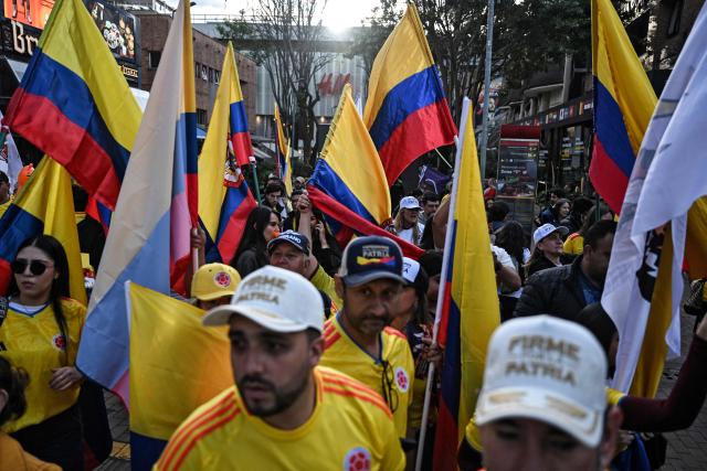 Supporters of Colombia's presidential candidate Abelardo de la Espriella, of the Salvadores de la Patria movement, attend a rally in Bogota on June 12, 2026. The Colombian Supreme Court of Justice on June 12, 2026, suspended a lower court ruling that had banned far-right presidential candidate Abelardo de la Espriella from using national symbols and his signature slogan, "Firm for the homeland". The 47-year-old lawyer often uses the military salute of the armed forces and national insignia at political rallies, which are filled with Colombian flags and national football team shirts. Colombia will hold a presidential runoff election on June 21. (Photo by Juan BARRETO / AFP)
