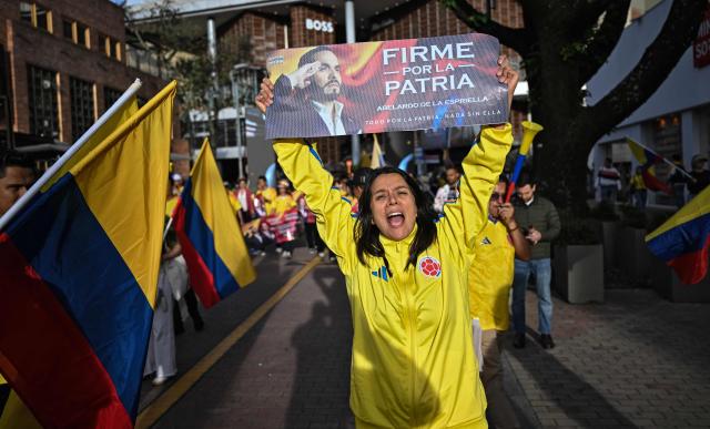 Supporters of Colombia's presidential candidate Abelardo de la Espriella, of the Salvadores de la Patria movement, attend a rally in Bogota on June 12, 2026. The Colombian Supreme Court of Justice on June 12, 2026, suspended a lower court ruling that had banned far-right presidential candidate Abelardo de la Espriella from using national symbols and his signature slogan, "Firm for the homeland". The 47-year-old lawyer often uses the military salute of the armed forces and national insignia at political rallies, which are filled with Colombian flags and national football team shirts. Colombia will hold a presidential runoff election on June 21. (Photo by Juan BARRETO / AFP)