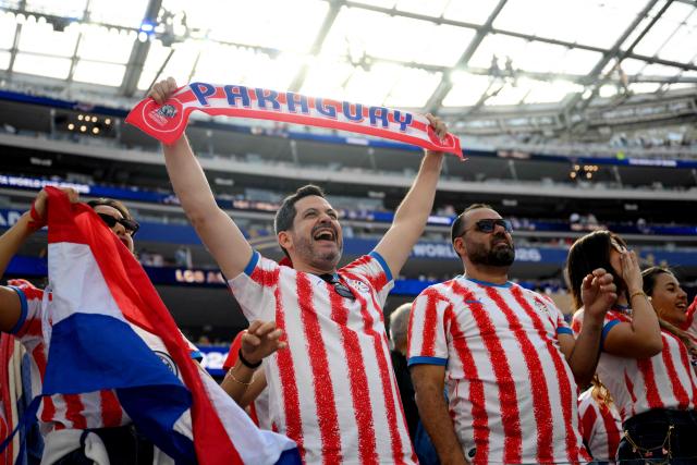 Paraguay's fans cheer for their team during the opening ceremony of the 2026 World Cup football tournament ahead of the Group D football match between USA and Paraguay at the Los Angeles Stadium in Inglewood on June 12, 2026. (Photo by Patrick T. Fallon / AFP)