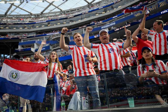 Paraguay's fans cheer for their team during the opening ceremony of the 2026 World Cup football tournament ahead of the Group D football match between USA and Paraguay at the Los Angeles Stadium in Inglewood on June 12, 2026. (Photo by Patrick T. Fallon / AFP)