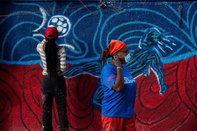 An artist draws children playing football on a wall in Port-au-Prince, Haiti, June 12, 2026. The 2026 World Cup football tournament kicked off in Mexico City on June 11. (Photo by Clarens SIFFROY / AFP)