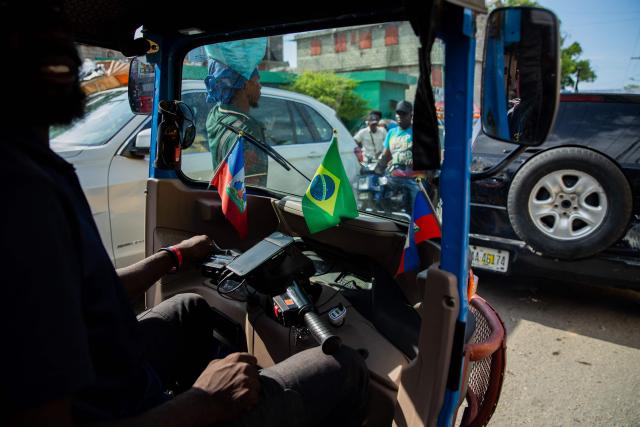 A man with Haitian and Brazilian flags on his vehicle drives in Port-au-Prince, Haiti, June 12, 2026. The 2026 World Cup football tournament kicked off in Mexico City on June 11. (Photo by Clarens SIFFROY / AFP)