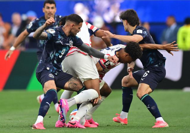Paraguay's defender #06 Junior Alonso (L) and US midfielder #04 Tyler Adams (2nd R) fight for the ball during the 2026 World Cup Group D football match between USA and Paraguay at the Los Angeles Stadium in Inglewood on June 12, 2026. (Photo by Frederic J. BROWN / AFP)
