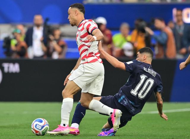 US defender #02 Sergino Dest (L) and Paraguay's midfielder #10 Miguel Almiron fight for the ball during the 2026 World Cup Group D football match between USA and Paraguay at the Los Angeles Stadium in Inglewood on June 12, 2026. (Photo by Frederic J. BROWN / AFP)