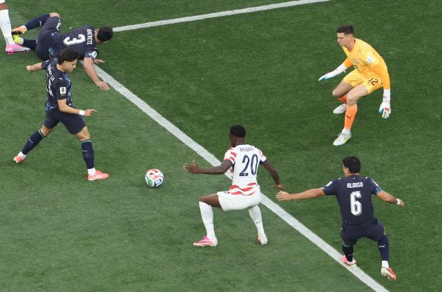 Paraguay's midfielder #16 Damian Bobadilla (R) scores an own goal during the 2026 World Cup Group D football match between USA and Paraguay at the Los Angeles Stadium in Inglewood on June 12, 2026. (Photo by Valerie MACON / AFP)