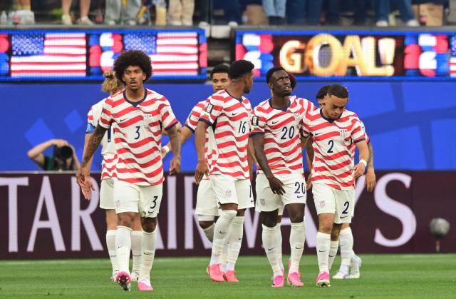 US defender #16 Alex Freeman, forward #20 Folarin Balogun and defender #02 Sergino Dest celebrate their team's first goal scored own goal by Paraguay's midfielder #16 Damian Bobadilla during the 2026 World Cup Group D football match between USA and Paraguay at the Los Angeles Stadium in Inglewood on June 12, 2026. (Photo by Frederic J. BROWN / AFP)