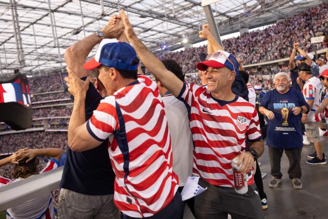 USA fans celebrate after their team scored their first goal during the 2026 World Cup Group D football match between USA and Paraguay at the Los Angeles Stadium in Inglewood, California, on June 12, 2026. (Photo by ETIENNE LAURENT / AFP)