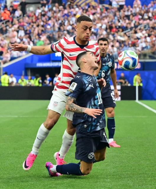 US defender #02 Sergino Dest (L) and Paraguay's midfielder #10 Miguel Almiron fight for the ball during the 2026 World Cup Group D football match between USA and Paraguay at the Los Angeles Stadium in Inglewood on June 12, 2026. (Photo by Frederic J. BROWN / AFP)