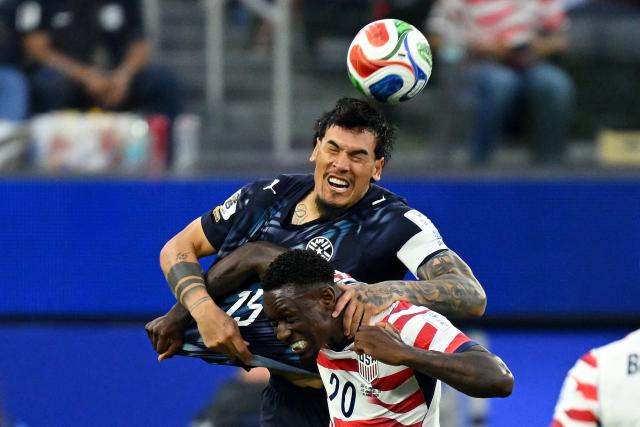 Paraguay's defender #15 Gustavo Gomez and US forward #20 Folarin Balogun fight for the ball during the 2026 World Cup Group D football match between USA and Paraguay at the Los Angeles Stadium in Inglewood on June 12, 2026. (Photo by Patrick T. Fallon / AFP)