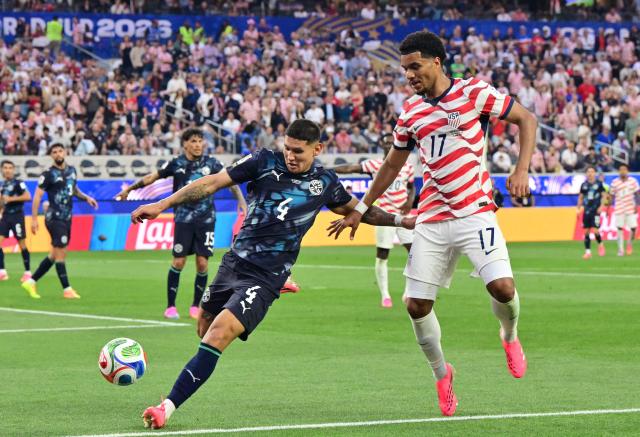 Paraguay's defender #04 Juan Jose Caceres and US midfielder #17 Malik Tillman fight for the ball during the 2026 World Cup Group D football match between USA and Paraguay at the Los Angeles Stadium in Inglewood on June 12, 2026. (Photo by Frederic J. BROWN / AFP)