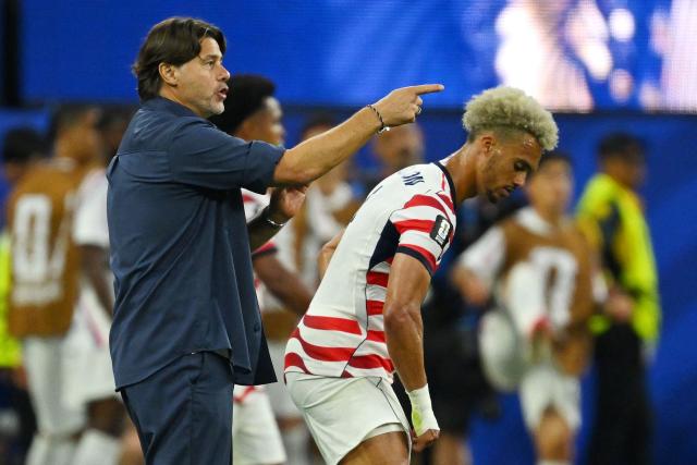 US Argentine head coach Mauricio Pochettino gestures past defender #05 Antonee Robinson  during the 2026 World Cup Group D football match between USA and Paraguay at the Los Angeles Stadium in Inglewood on June 12, 2026. (Photo by Patrick T. Fallon / AFP)