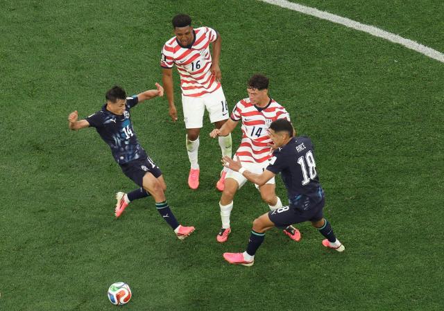 Paraguay's midfielder #14 Andres Cubas and US midfielder #14 Sebastian Berhalter fight for the ball during the 2026 World Cup Group D football match between USA and Paraguay at the Los Angeles Stadium in Inglewood on June 12, 2026. (Photo by Valerie MACON / AFP)