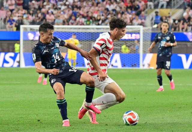 Paraguay's midfielder #14 Andres Cubas (L) and US midfielder #07 Giovanni Reyna fight for the ball during the 2026 World Cup Group D football match between USA and Paraguay at the Los Angeles Stadium in Inglewood on June 12, 2026. (Photo by Frederic J. BROWN / AFP)