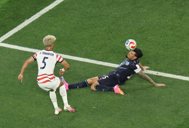 US defender #05 Antonee Robinson and Paraguay's defender #15 Gustavo Gomez fight for the ball during the 2026 World Cup Group D football match between USA and Paraguay at the Los Angeles Stadium in Inglewood on June 12, 2026. (Photo by Valerie MACON / AFP)