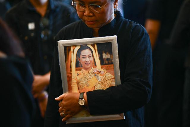A mourner holds a portrait of the late Thai Princess Bajrakitiyabha Mahidol at the palace in Bangkok on June 13, 2026. Thai Princess Bajrakitiyabha Mahidol, the king's eldest daughter, has died aged 47, the royal palace announced on June 12, more than three years after she was hospitalised following a sudden illness. (Photo by ANTHONY WALLACE / AFP)