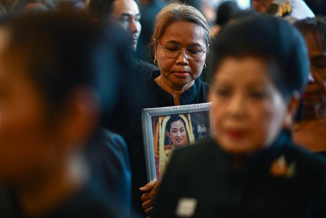 A mourner holds a portrait of the late Thai Princess Bajrakitiyabha Mahidol while paying her respects at the palace in Bangkok on June 13, 2026. Thai Princess Bajrakitiyabha Mahidol, the king's eldest daughter, has died aged 47, the royal palace announced on June 12, more than three years after she was hospitalised following a sudden illness. (Photo by ANTHONY WALLACE / AFP)