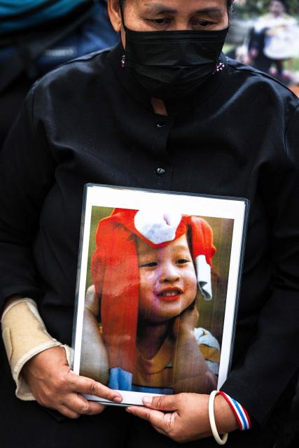 A mourner holds a photo of late Thai Princess Bajrakitiyabha Mahidol at Chulalongkorn Hospital in Bangkok on June 13, 2026. Thai Princess Bajrakitiyabha Mahidol, the king's eldest daughter, has died aged 47, the royal palace announced on June 12, more than three years after she was hospitalised following a sudden illness. (Photo by chanakarn LAOSARAKHAM / AFP)