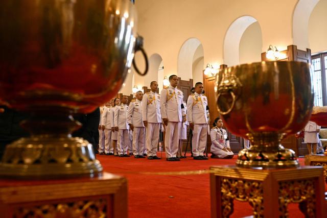 Officials line up to pay respects in front of a portrait of the late Thai Princess Bajrakitiyabha Mahidol in the royal throne hall at the Grand Palace in Bangkok on June 13, 2026. Thai Princess Bajrakitiyabha Mahidol, the king's eldest daughter, has died aged 47, the royal palace announced on June 12, more than three years after she was hospitalised following a sudden illness. (Photo by ANTHONY WALLACE / AFP)