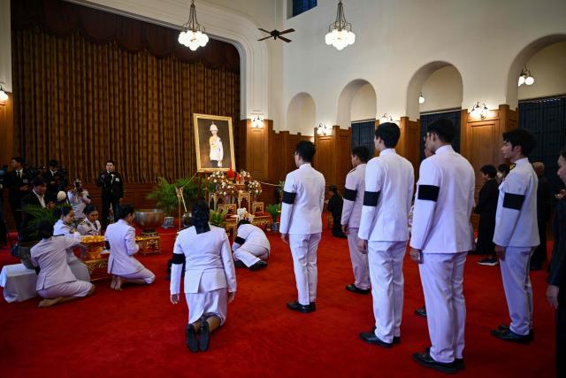 Officials pay respects in front of a portrait of the late Thai Princess Bajrakitiyabha Mahidol in the royal throne hall at the Grand Palace in Bangkok on June 13, 2026. Hundreds of black-clad Thai mourners gathered at the royal palace in Bangkok on June 13, awaiting the arrival of the body of the king's eldest daughter a day after her death was announced. (Photo by ANTHONY WALLACE / AFP)