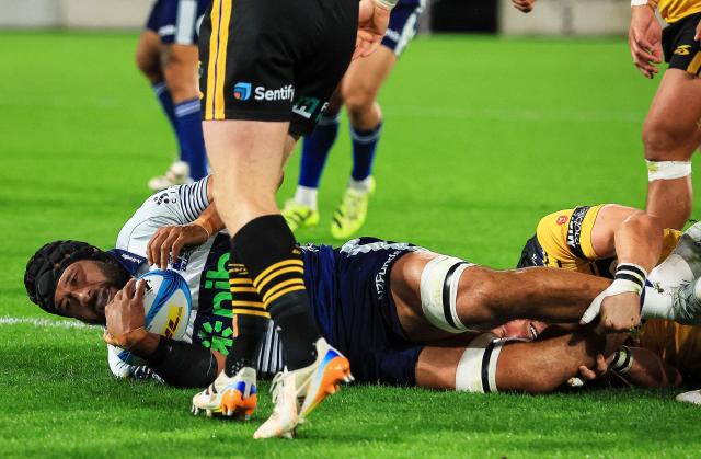 Blues Patrick Tuipulotu scores a try during the Super Rugby Pacific semi-final match between the Wellington Hurricanes and Auckland Blues in Wellington on June 13, 2026. (Photo by Grant Down / AFP)