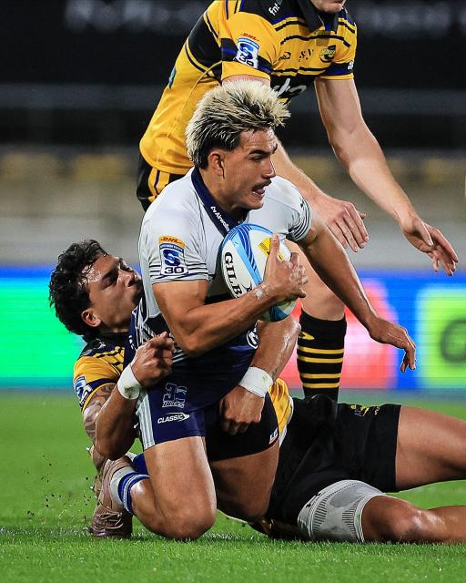 Blues Xavi Taele is tackled by Hurricanes Billy Proctor during the Super Rugby Pacific semi-final match between the Wellington Hurricanes and Auckland Blues in Wellington on June 13, 2026. (Photo by Grant Down / AFP)