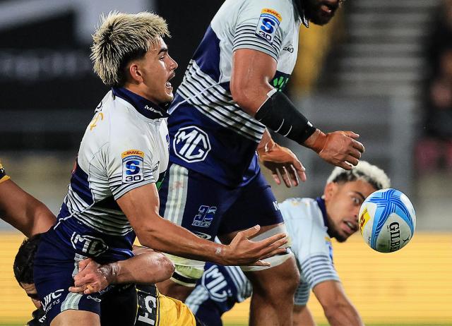 Blues Xavi Taele offloads the ball during the Super Rugby Pacific semi-final match between the Wellington Hurricanes and Auckland Blues in Wellington on June 13, 2026. (Photo by Grant Down / AFP)