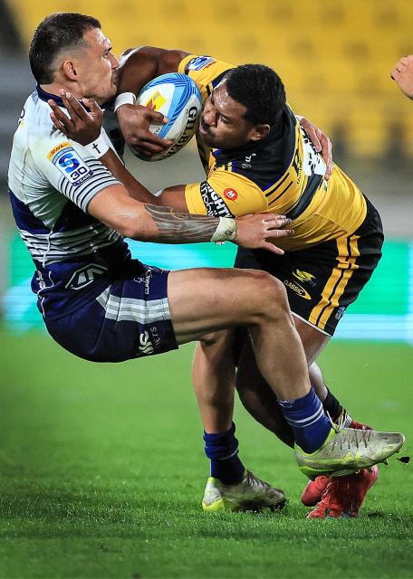 Hurricanes Kini Naholo (R) is tackled during the Super Rugby Pacific semi-final match between the Wellington Hurricanes and Auckland Blues in Wellington on June 13, 2026. (Photo by Grant Down / AFP)
