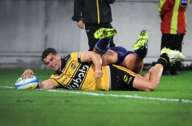 Hurricanes Josh Moorby dives in to score a try during the Super Rugby Pacific semi-final match between the Wellington Hurricanes and Auckland Blues in Wellington on June 13, 2026. (Photo by Grant Down / AFP)