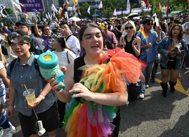 Participants take part in a parade during a Pride event in support of LGBTQ rights as part of the Seoul Queer Culture Festival in Seoul on June 13, 2026. (Photo by Jung Yeon-je / AFP)