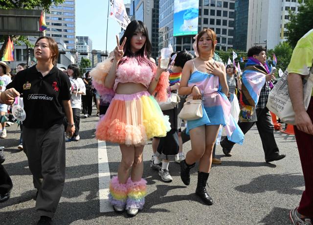 Participants take part in a parade during a Pride event in support of LGBTQ rights as part of the Seoul Queer Culture Festival in Seoul on June 13, 2026. (Photo by Jung Yeon-je / AFP)