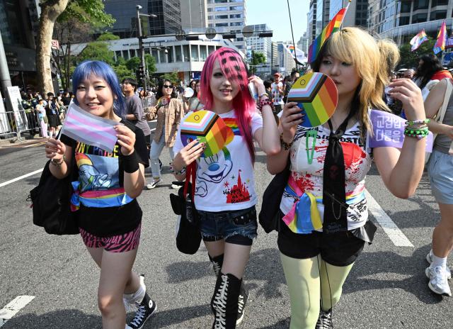 Participants take part in a parade during a Pride event in support of LGBTQ rights as part of the Seoul Queer Culture Festival in Seoul on June 13, 2026. (Photo by Jung Yeon-je / AFP)