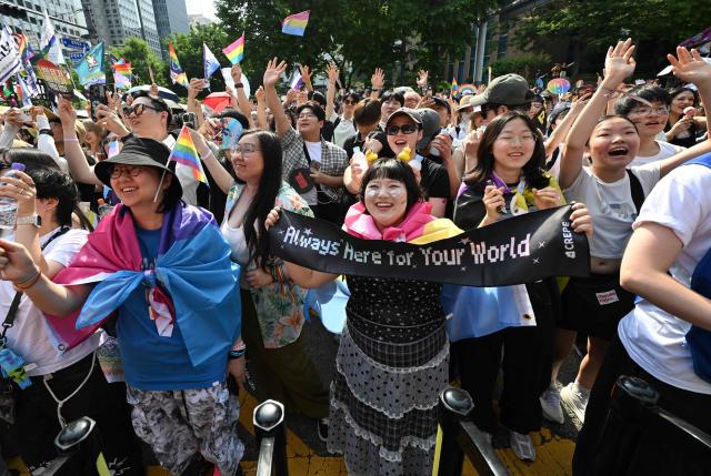 Participants take part in a parade during a Pride event in support of LGBTQ rights as part of the Seoul Queer Culture Festival in Seoul on June 13, 2026. (Photo by Jung Yeon-je / AFP)