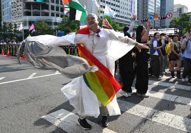 A Buddhist monk takes part in a parade during a Pride event in support of LGBTQ rights as part of the Seoul Queer Culture Festival in Seoul on June 13, 2026. (Photo by Jung Yeon-je / AFP)