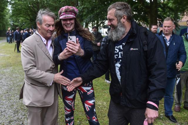 Restore Britain leader Rupert Lowe (L) meets up with volunteers before they go out to campaign ahead of the Makerfield by-election on June 18, west of Manchester, north-west England on June 13, 2026. (Photo by PETER POWELL / AFP)
