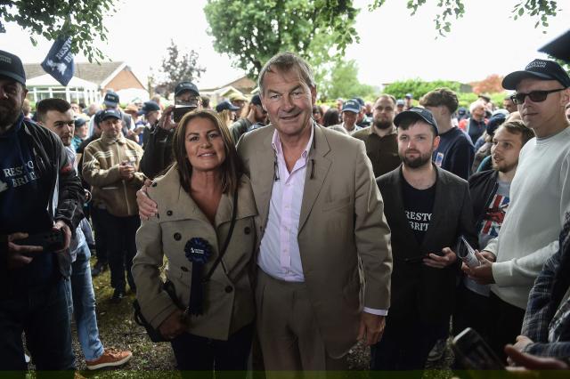 Restore Britain leader Rupert Lowe (R) poses with Restore Britain candidate Rebecca Shepherd (L) as they meet with volunteers before campaigning ahead of the Makerfield by-election on June 18, west of Manchester, north-west England on June 13, 2026. (Photo by PETER POWELL / AFP)