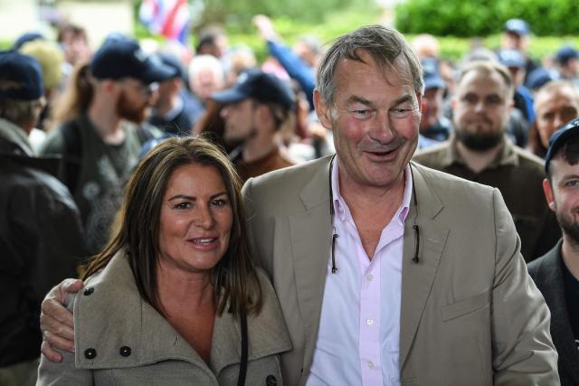 Restore Britain leader Rupert Lowe (R) poses with Restore Britain candidate Rebecca Shepherd (L) as they meet with volunteers before campaigning ahead of the Makerfield by-election on June 18, west of Manchester, north-west England on June 13, 2026. (Photo by PETER POWELL / AFP)