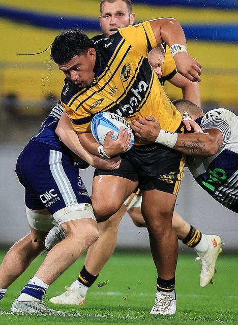 Hurricanes Xavier Numia is tackled during the Super Rugby Pacific semi-final match between the Wellington Hurricanes and Auckland Blues in Wellington on June 13, 2026. (Photo by Grant Down / AFP)