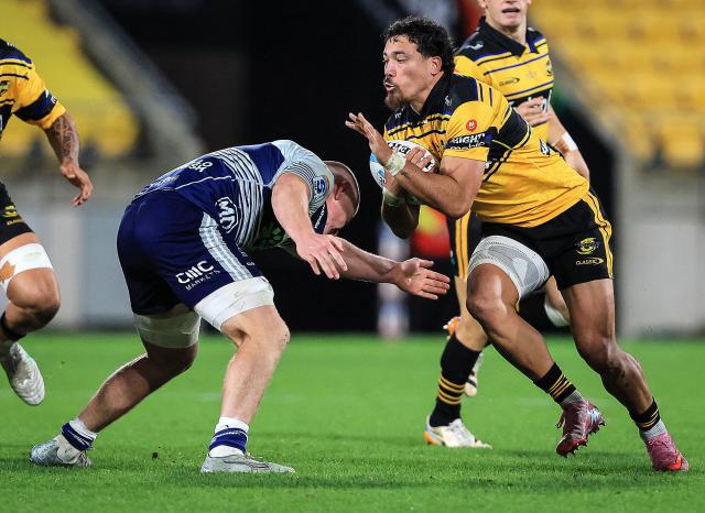 Hurricanes Billy Proctor tries to evade a tackle during the Super Rugby Pacific semi-final match between the Wellington Hurricanes and Auckland Blues in Wellington on June 13, 2026. (Photo by Grant Down / AFP)